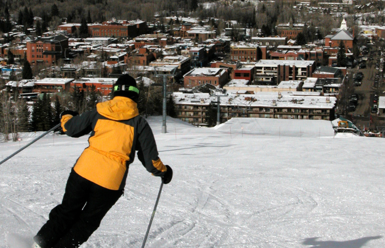 Person skiing down a mountain in Aspen Colorado